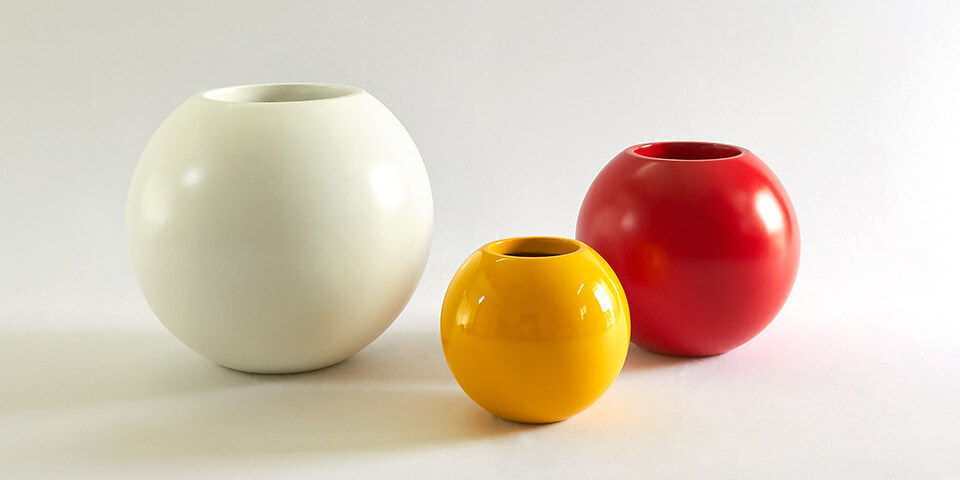 round frp planter in yellow, white & red colours for a modern interior