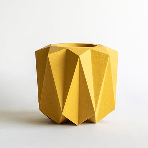 Geometric shaped fiber planter in yellow color and rustic finish